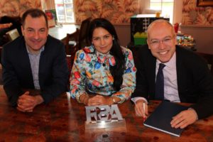Priti Patel with Jamie Burles, MD of Greater Anglia (left), Jonathan Denby, Head of Corporate Affairts and the Rail Operator of the Year trophy, at the Valero Lounge, Witham.