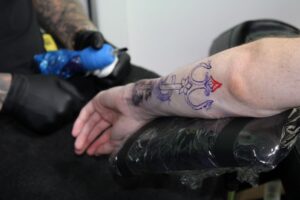 Work in progress – a tattoo being created during Priti Patel’s visit to Artisan Inks.