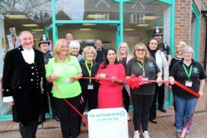 Priti Patel MP, Simon Brice DL, the High Sheriff of Essex (far left) and Tina Townsend, Chair of the Hub’s board of trustees with volunteers and supporters cutting the ribbon to declare the new Witham Hub in the Grove Centre open.