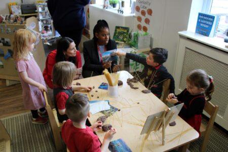 Priti Patel MP with Area Director Marcia Brown, joins older children at the Busy Bees Nursery.