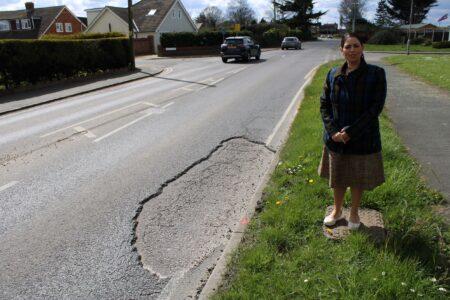 Priti checks out the very large pothole on Maldon Road, near the junction with Station Road, Tiptree.