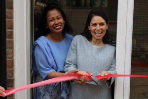 Priti Patel and Ila Achmed cutting the ribbon to formally open the new vegan and organic food store in the Grove Centre.