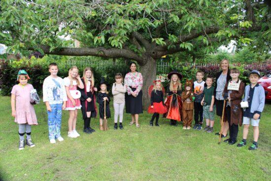 Priti Patel MP with students at Silver End Academy, in their costumes for Get Witham Reading day last year,(9th July 2021)